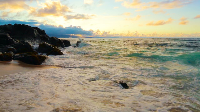 Sunset on the beach - Tranquil idyllic scene of a golden sunset over the sea, Steadicam Shot of powerful waves crashing on the sand. Landscape Nature Scenic Planet Earth Concept.