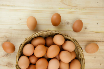 Full of Eggs put in a wicker basket in wooden background