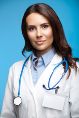 Happy smiling female doctor, on blue