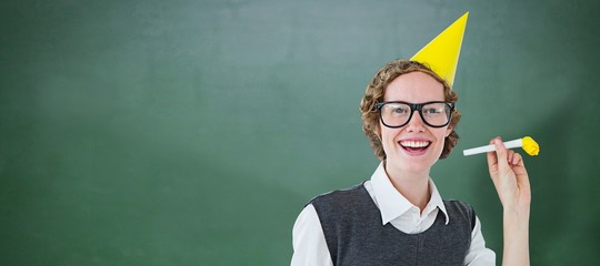 Composite image of geeky hipster in party hat with horn