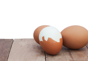 Still Life-Eggs laid on the old wooden floor Peel the eggs laid in front of a white background.
