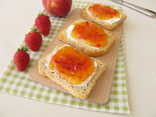 Twice-baked bread with with cream cheese and peach-strawberry-jam