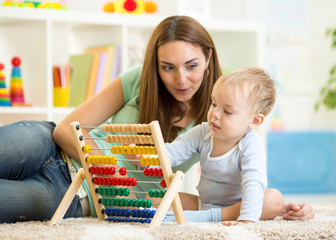 kid and mother playing with abacus