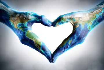 earth's day celebration - hands shaped heart with world map
