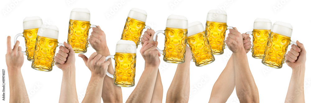 Wall mural Hands with beer mugs isolated on white background