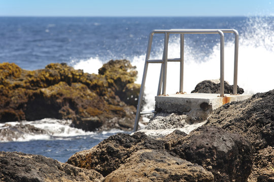 Rocky pool beach with stairs in Biscoitos. Terceira island. Azor