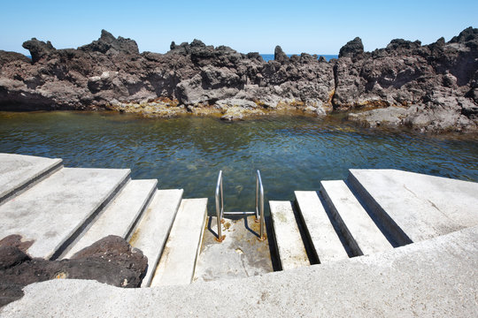 Rocky pool beach with stairs in Biscoitos. Terceira island. Azor