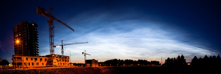 Noctilucent clouds glowing at night sky panorama