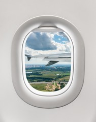 Looking out the window of a plane to the ground
