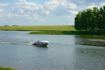 Fototapeta premium man on a boat floating on the lake