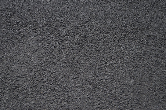 A close up view of a road surface, suitable for use as a background or texture.