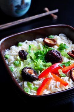 ramen noodles with shiitake mushrooms, green peas, sweet pepper and coriander