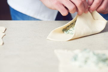 Vegetarian bakery concept. Cook's hands putting filler