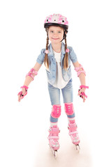 Cute smiling little girl in pink roller skates