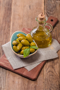 Olive oil and olives in bowl