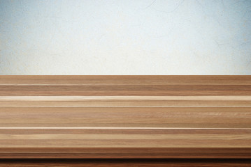 Empty wooden table over grunge cement wall background