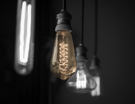 Hanged light bulbs in dark room color-splash tone