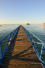 Fototapeta premium Long pier dan beautiful coral at Mabul Island