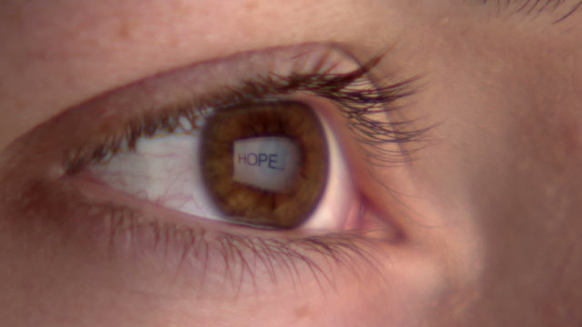 Eye watching the screen with reflection of the word 