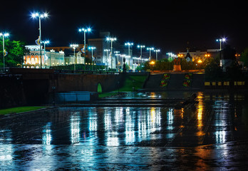 Fototapeta na wymiar Night lights of city reflected in wet asphalt