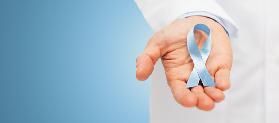 doctor hand with prostate cancer awareness ribbon - obrazy, fototapety, plakaty