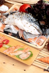 Salmon head for cooking and fresh salmon fillets .