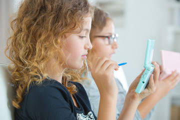 Two young sisters playing video gales