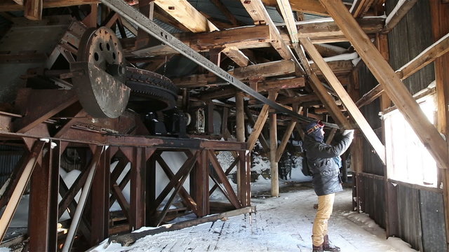 Tourist visiting the old abandoned coal mine in the town of Lrongyir, Svalbard.