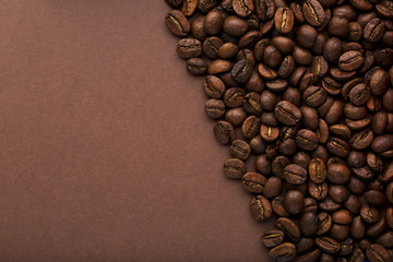 Close up roasted coffee beans on an brown background