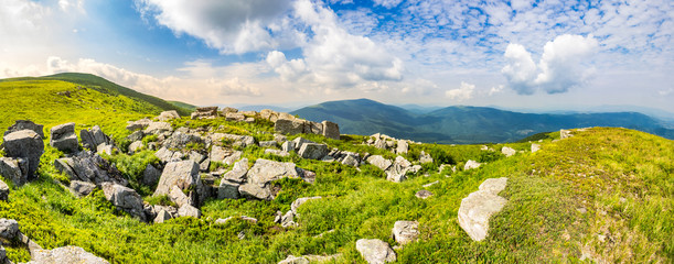 stones in valley on top of mountain range at sunrise