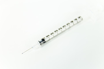 Syringe on white table