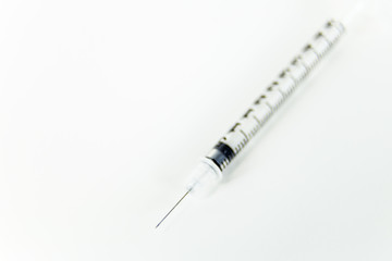 Fototapeta premium Syringe on white table