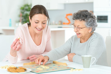 Obraz na płótnie Canvas Elderly woman playing a board game