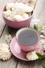 French meringue cookies in bowl on grey wooden background
