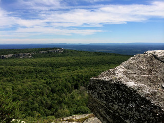 Fototapeta na wymiar Massive rocks and view to the valley at Minnewaska State Park Reserve Upstate NY during summer time