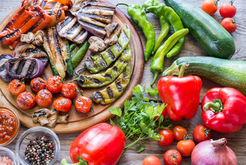 Grilled and fresh vegetables on the wooden board