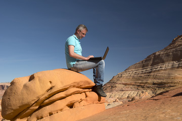 Business man at work in Monument Valley