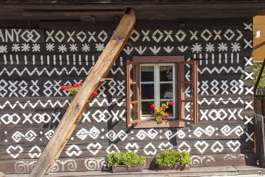 Old wooden window. Unique decoration of log houses based on patterns used in traditional embroidery in village of Cicmany, UNESCO World Heritage Site, Slovakia

