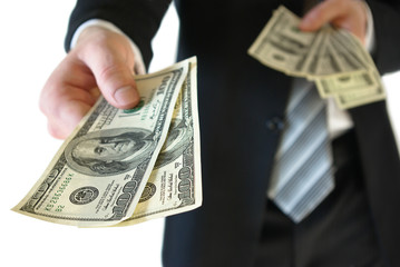 A man in a business suit offers money
