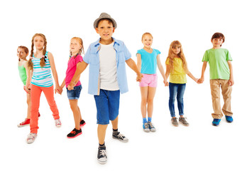 Obraz premium Handsome boy with many friends hold hands together