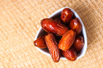 dried dates in bowl on table background