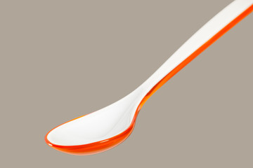 Big orange plastic spoon