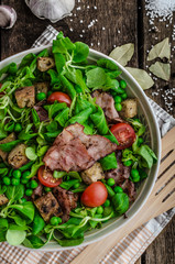 Fresh salad with bacon and croutons