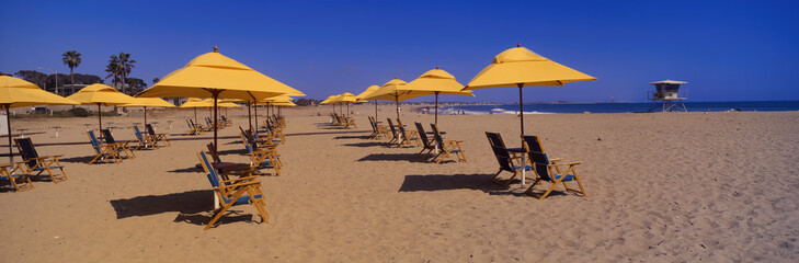 Yellow umbrellas and beach chairs on Ventura beach, California