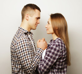 lovely happy couple hugging over grey background.