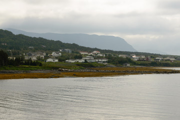 Fototapeta na wymiar Houses on the rocky shore, Newfoundland, Canada