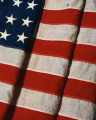 This is a vertical view of a folded American flag. It is a vintage flag with 48 stars. It is folded...