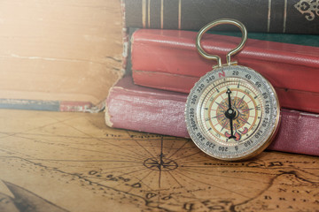 Vintage compass lies on an ancient map