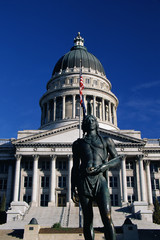 This is the State Capitol building. It has a bronze statue of a Massassait Indian in front of it....