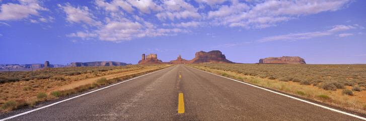 This is Route 163 that runs through the Navajo Indian Reservation. The road runs large through the...